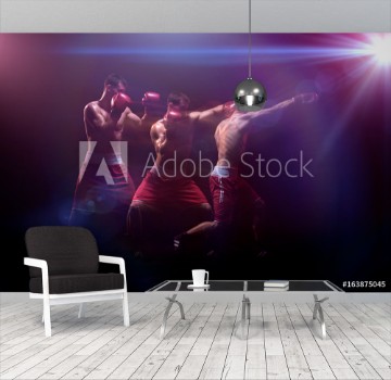 Bild på The boxer boxing in a dark studio
